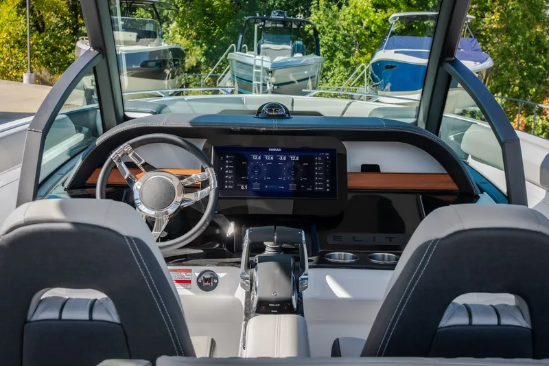 Slide: The Image of 2027 Monterey Elite 27 OB boat dashboard with modern steering and digital display. - 19