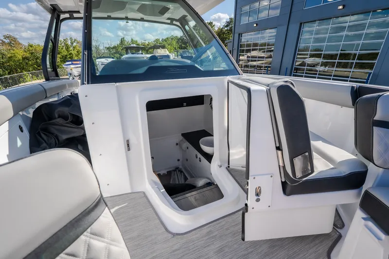 Slide: The Image of Interior view of 2027 Monterey Elite 27 OB boat, featuring seating and storage area. - 48