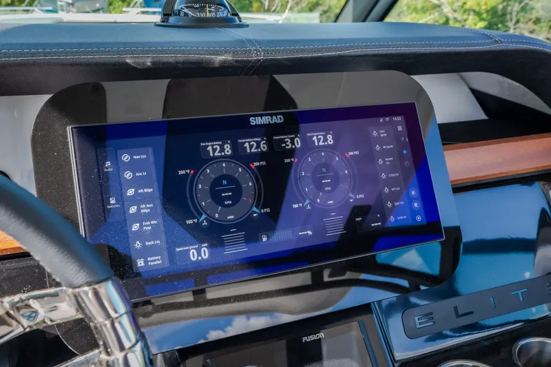 Slide: The Image of Dashboard of 2027 Monterey Elite 27 OB boat with Simrad display showing navigation data. - 26