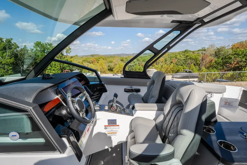 Slide: The Image of Interior view of 2027 Monterey Elite 27 OB boat with modern steering and seating. - 29