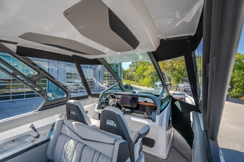 Slide: The Image of Interior view of 2027 Monterey Elite 27 OB boat with modern dashboard and seating. - 62