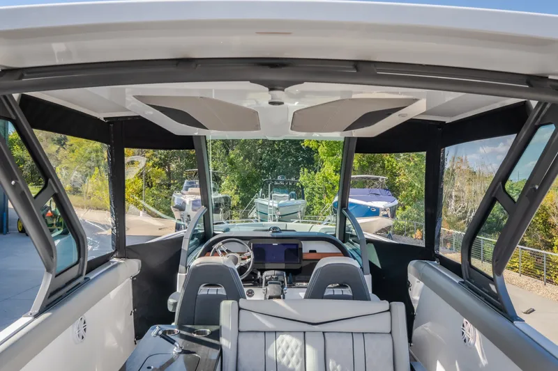 Slide: The Image of Interior view of 2027 Monterey Elite 27 OB boat, featuring modern seating and dashboard. - 65