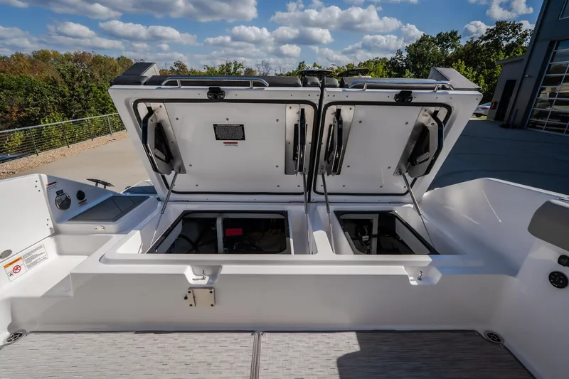 Slide: The Image of 2027 Monterey Elite 27 OB boat storage compartments open under a clear sky. - 31