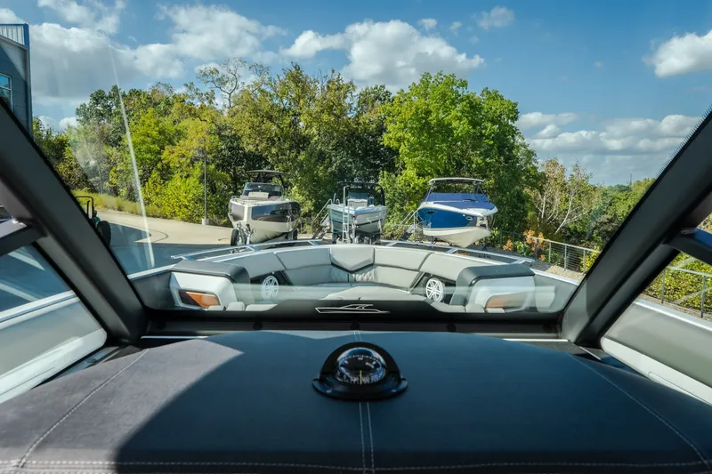 Slide: The Image of Interior view of 2027 Monterey Elite 27 OB boat, showcasing sleek design and outdoor scenery. - 27