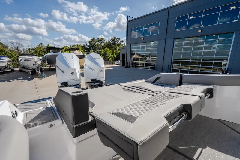 Slide: The Image of 2027 Monterey Elite 27 OB boat with dual Mercury engines at a marina. - 36