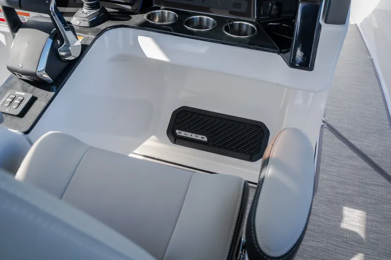 Slide: The Image of Interior of 2027 Monterey Elite 27 OB boat, featuring helm controls and cup holders. - 38
