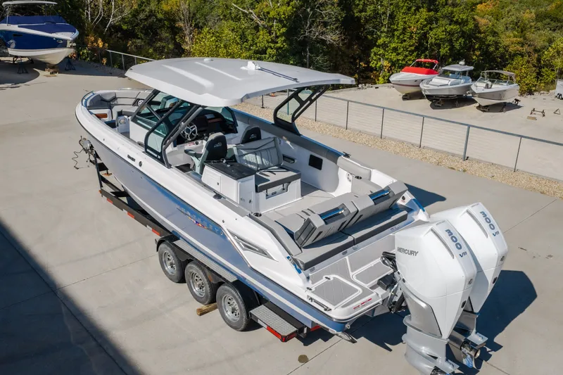 Slide: The Image of 2027 Monterey Elite 27 OB boat on trailer, featuring dual Mercury outboard engines. - 67