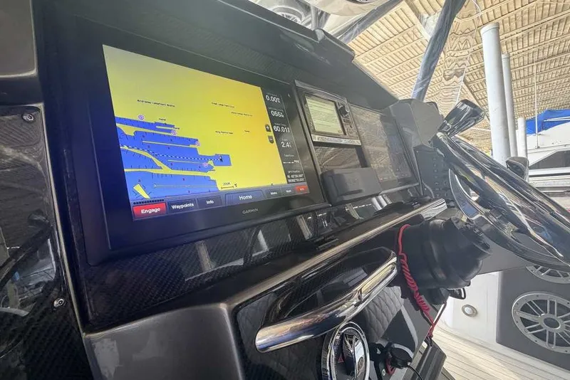 Slide: The Image of 2014 Nor-Tech 340 Sport dashboard with Garmin navigation display and steering wheel. - 17