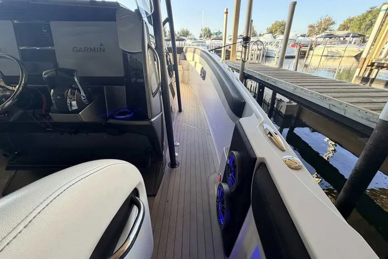 Slide: The Image of 2014 Nor-Tech 340 Sport boat interior with Garmin navigation, docked at marina. - 21