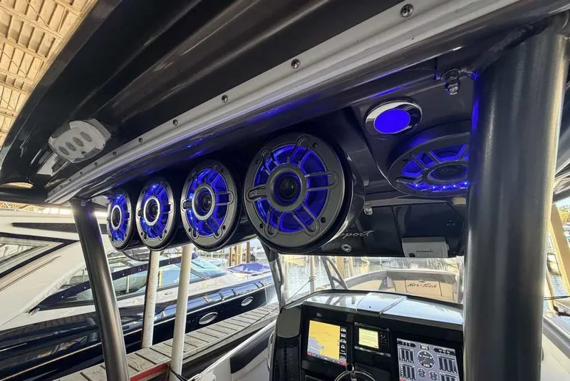 Slide: The Image of 2014 Nor-Tech 340 Sport boat with blue LED-lit speakers and advanced dashboard controls. - 9