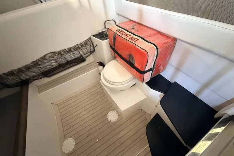 Slide: The Image of Interior of 2014 Nor-Tech 340 Sport boat with toilet and life jacket storage. - 31