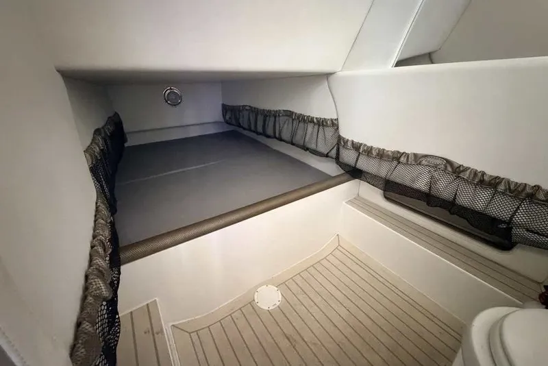 Slide: The Image of 2014 Nor-Tech 340 Sport cabin interior with storage nets and wooden flooring. - 30