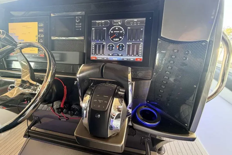 Slide: The Image of Dashboard of a 2014 Nor-Tech 340 Sport boat with advanced controls and displays. - 18