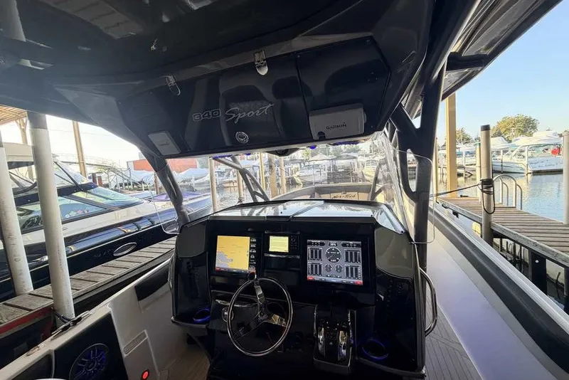Slide: The Image of Interior view of a 2014 Nor-Tech 340 Sport boat at a marina dock. - 10