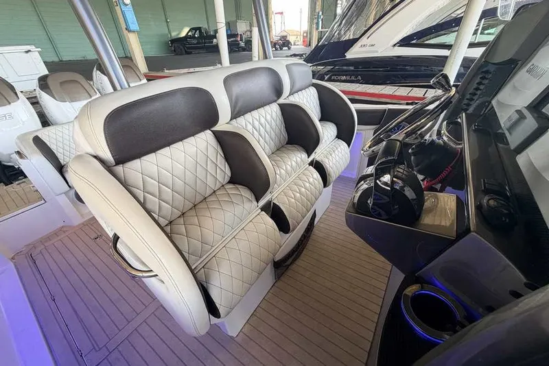 Slide: The Image of Luxurious seating on a 2014 Nor-Tech 340 Sport boat, featuring quilted upholstery. - 14