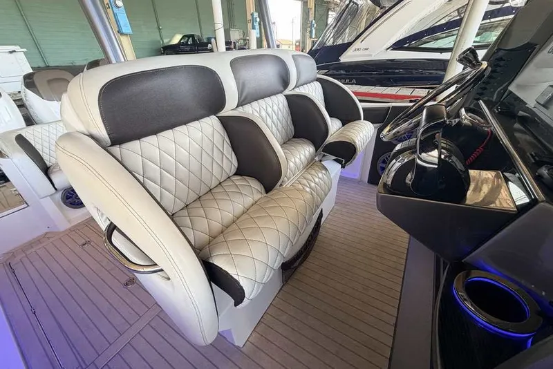 Slide: The Image of Luxurious seating on a 2014 Nor-Tech 340 Sport boat with quilted upholstery. - 12