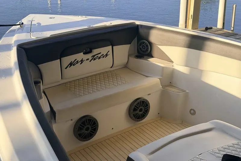 Slide: The Image of Interior of a 2014 Nor-Tech 340 Sport boat with cushioned seating and speakers. - 27