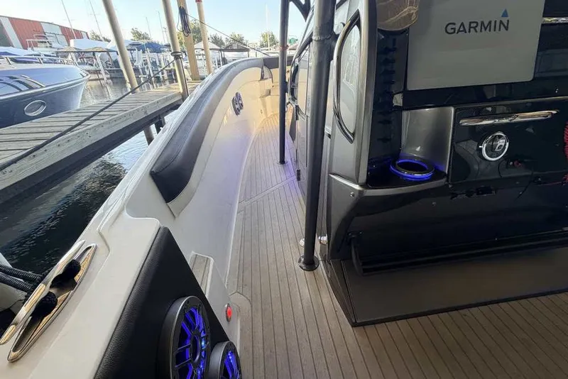 Slide: The Image of 2014 Nor-Tech 340 Sport boat interior with Garmin equipment, docked at marina. - 22