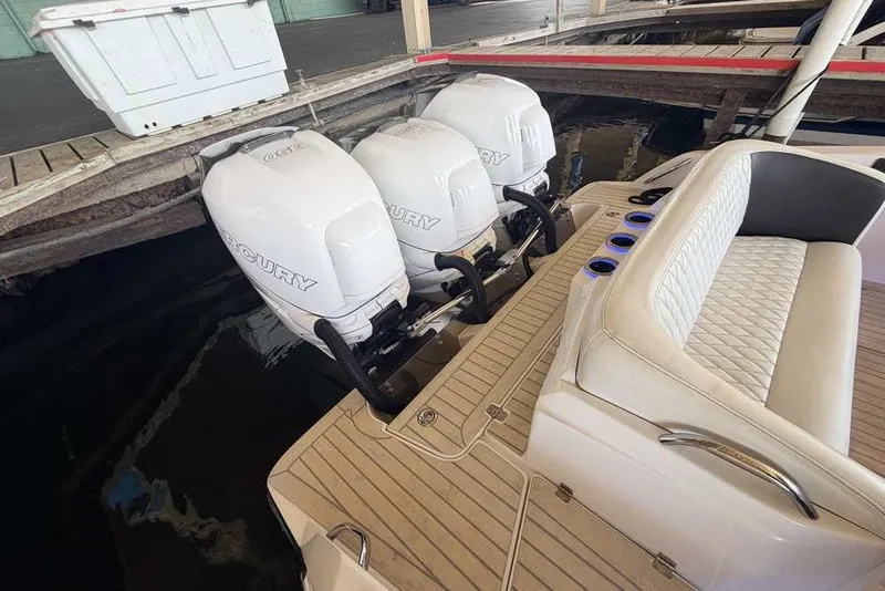 Slide: The Image of 2014 Nor-Tech 340 Sport boat with triple Mercury outboard engines at dock. - 3