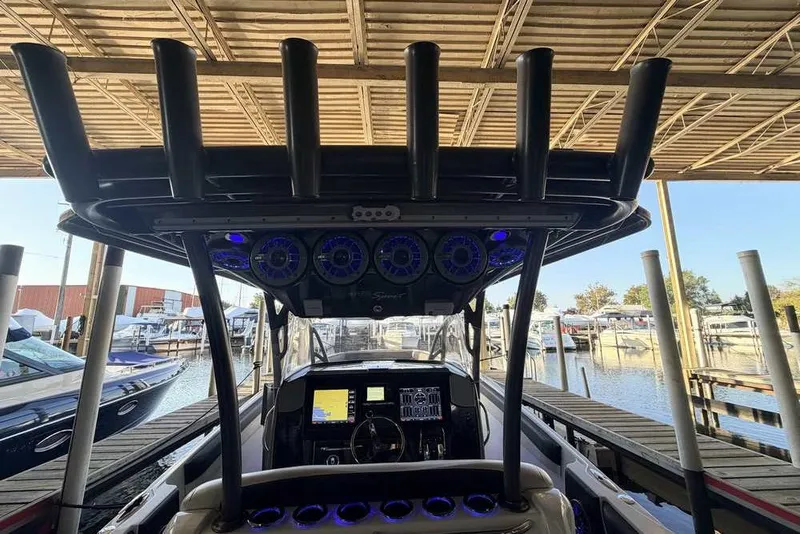 Slide: The Image of 2014 Nor-Tech 340 Sport boat interior with advanced dashboard and marina view. - 8