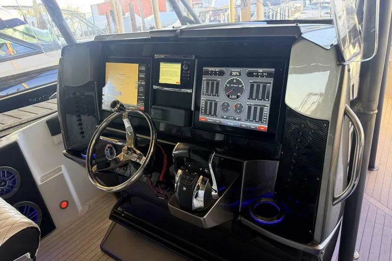Slide: The Image of Dashboard of a 2014 Nor-Tech 340 Sport boat with advanced navigation displays. - 15