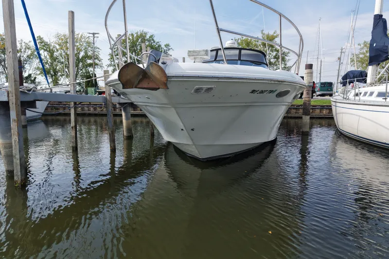 Slide: The Image of 1997 Sea Ray Sundancer 400 yacht docked in a marina, front view. - 4