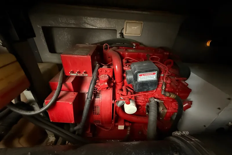 Slide: The Image of Engine compartment of a 1997 Sea Ray Sundancer 400, featuring a red marine engine. - 25