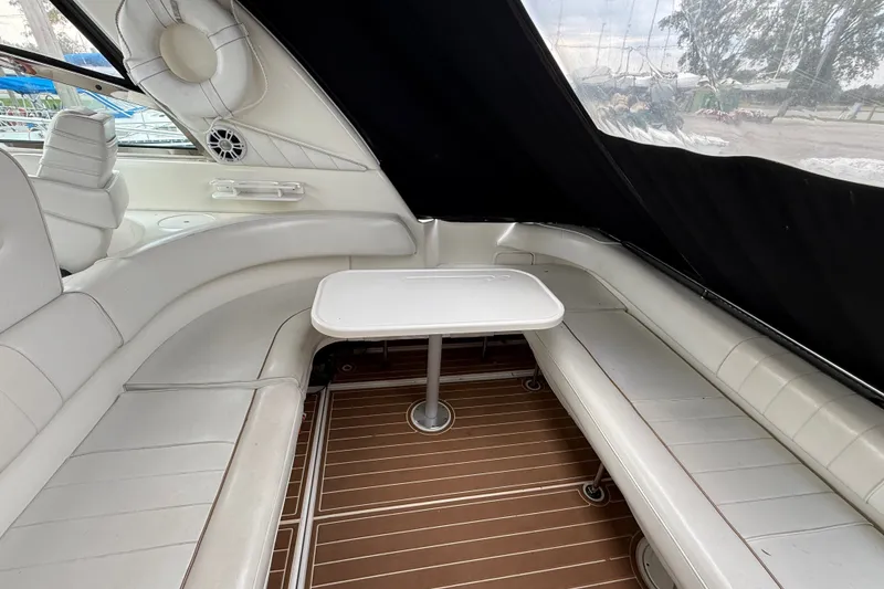 Slide: The Image of 1997 Sea Ray Sundancer 400 interior with white seating and a central table. - 17