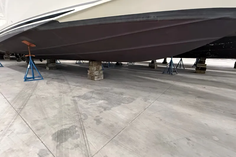 Slide: The Image of 1997 Sea Ray Sundancer 400 boat hull on stands in a storage facility. - 50