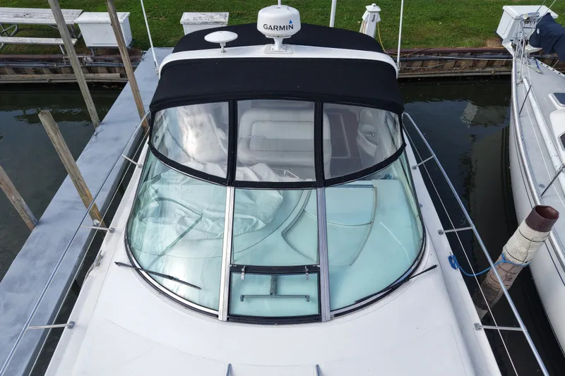 Slide: The Image of 1997 Sea Ray Sundancer 400 docked, featuring a black canopy and Garmin equipment. - 6