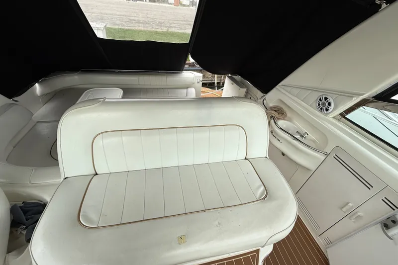 Slide: The Image of 1997 Sea Ray Sundancer 400 interior with white seating and wood flooring. - 18