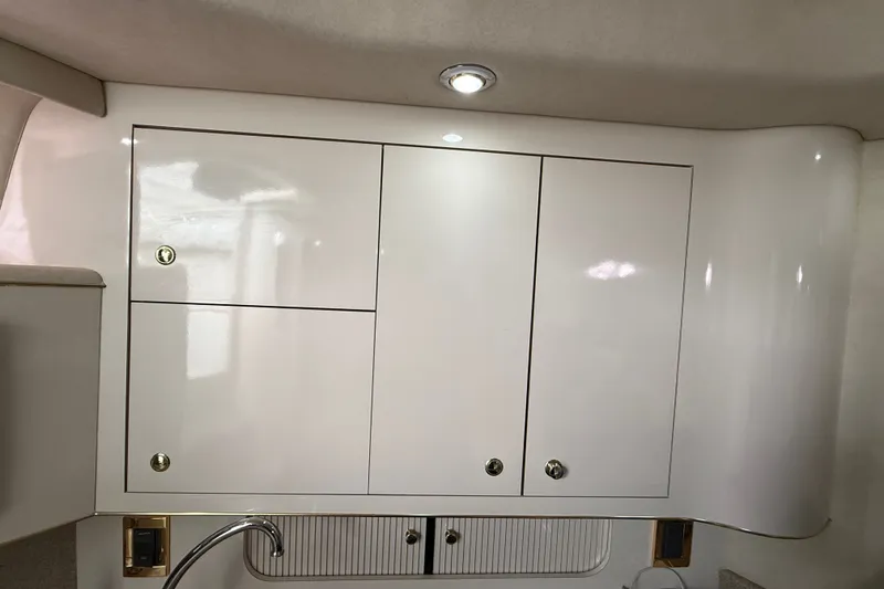 Slide: The Image of Interior cabinetry of a 1997 Sea Ray Sundancer 400 yacht, featuring sleek white finish. - 36