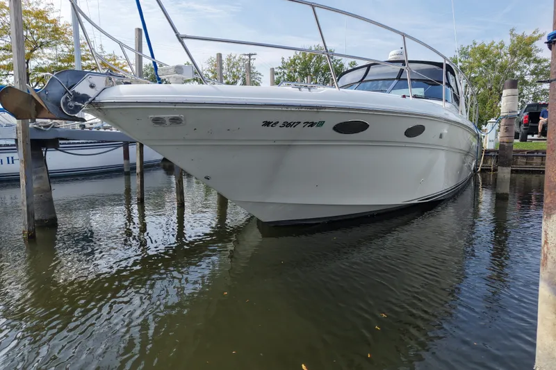 Slide: The Image of 1997 Sea Ray Sundancer 400 yacht docked in a marina, reflecting on calm water. - 5