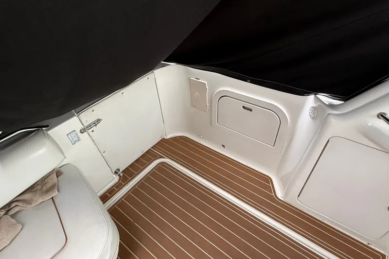 Slide: The Image of Interior view of a 1997 Sea Ray Sundancer 400 boat with wood-patterned flooring. - 13