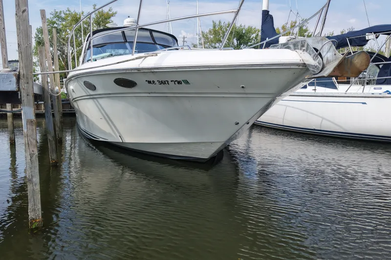 Slide: The Image of 1997 Sea Ray Sundancer 400 yacht docked in a marina, front view. - 3