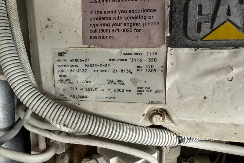 Slide: The Image of Close-up of a 1997 Sea Ray Sundancer 400 engine label with specifications and contact information. - 26