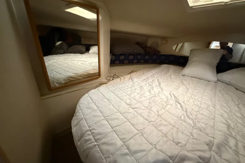Slide: The Image of Cozy cabin interior of 1997 Sea Ray Sundancer 400 with quilted bedding and mirror. - 44