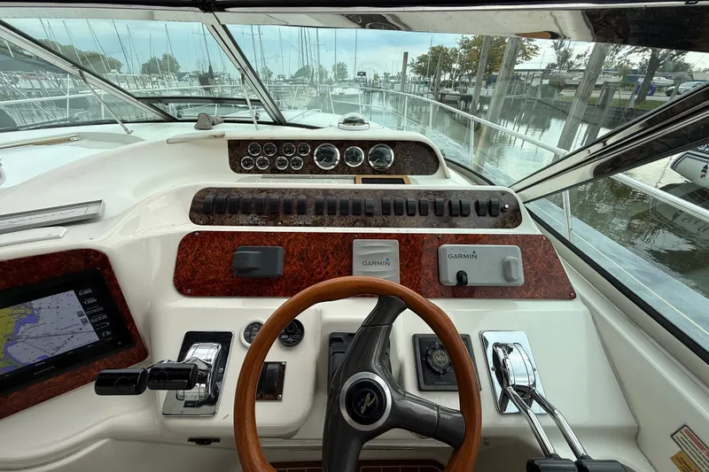 Slide: The Image of Cockpit view of a 1997 Sea Ray Sundancer 400 with navigation instruments and steering wheel. - 21