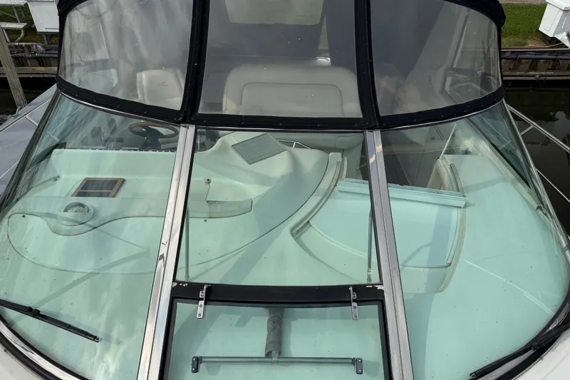 Slide: The Image of 1997 Sea Ray Sundancer 400 boat cockpit with clear windshield and steering wheel. - 11
