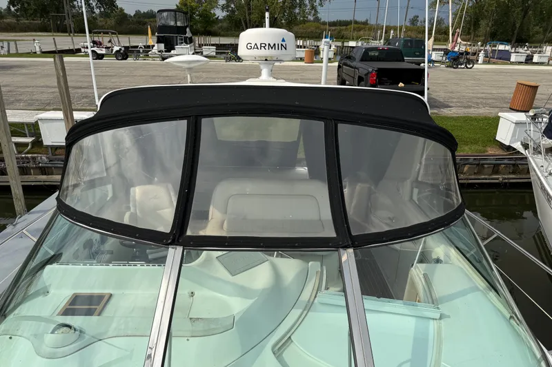 Slide: The Image of 1997 Sea Ray Sundancer 400 yacht docked, featuring Garmin equipment and sleek design. - 12