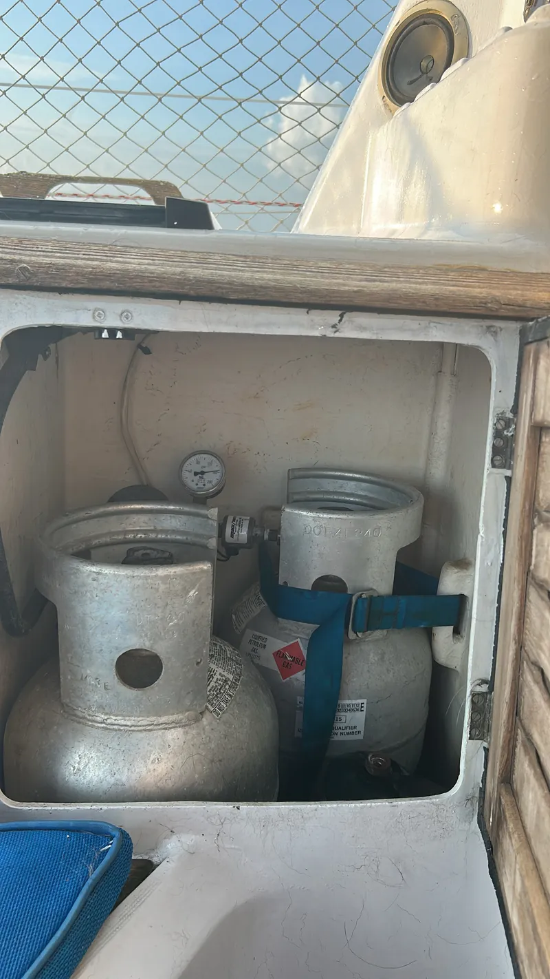 Slide: The Image of Gas cylinders in a storage compartment on a boat. - 11
