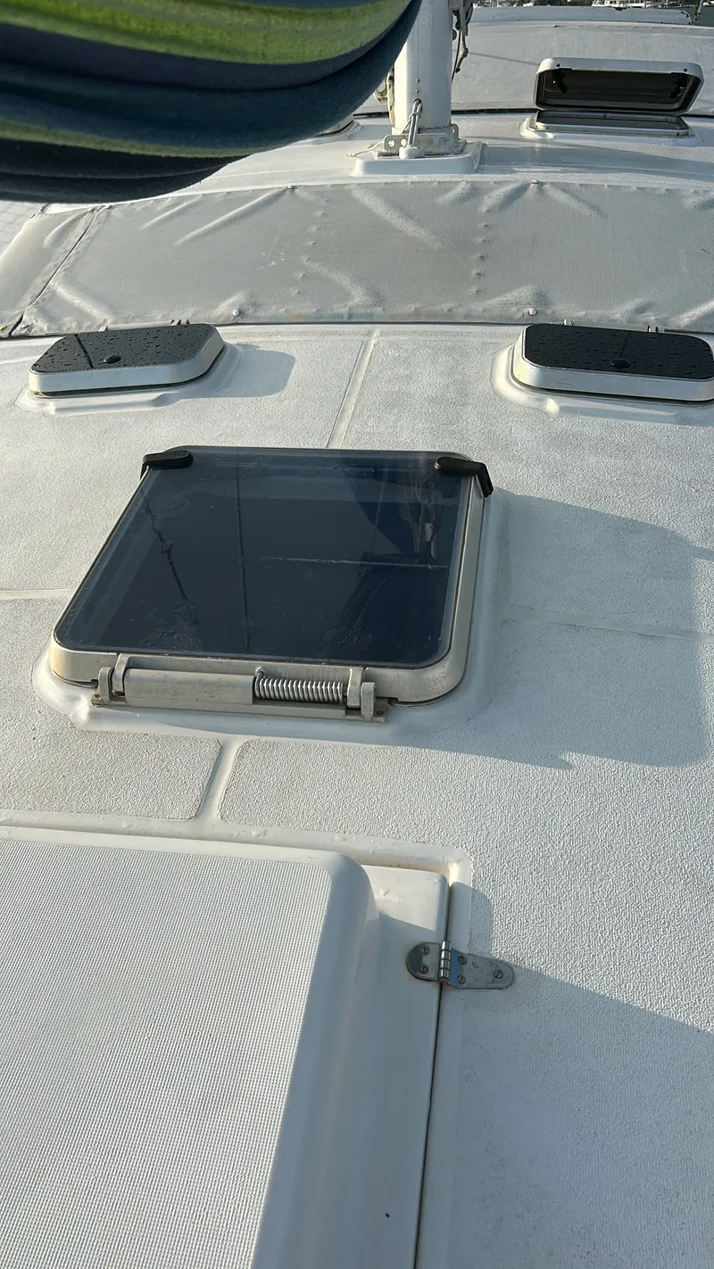 Slide: The Image of The image shows the deck of a 1990 Jeantot Privilege 39 with a hatch. - 19