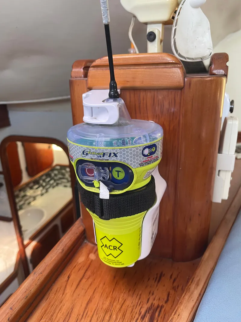 Slide: The Image of An ACR GlobalFix EPIRB is mounted on a wooden surface inside a boat. - 35