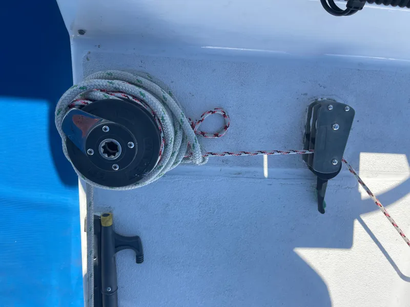 Slide: The Image of A rope is coiled around a winch on a boat, with a blue background. - 29