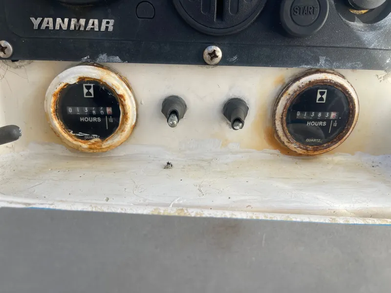 Slide: The Image of Close-up of two rusty hour meters on a boat, surrounded by switches. - 30