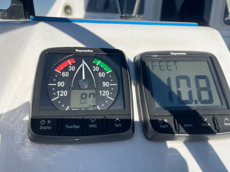 Slide: The Image of Two Raymarine instruments display wind speed and water depth on a boat. - 26