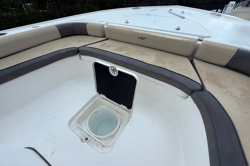 Slide: The Image of 2021 Tidewater 2500 Carolina Bay boat interior with seating and storage compartment. - 23