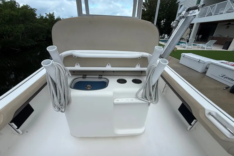 Slide: The Image of 2021 Tidewater 2500 Carolina Bay boat interior with fishing rod holders and storage. - 11