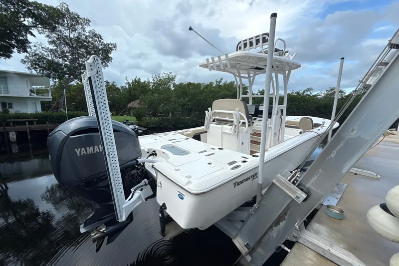 Slide: The Image of 2021 Tidewater 2500 Carolina Bay boat with Yamaha engine on a lift by the water. - 5