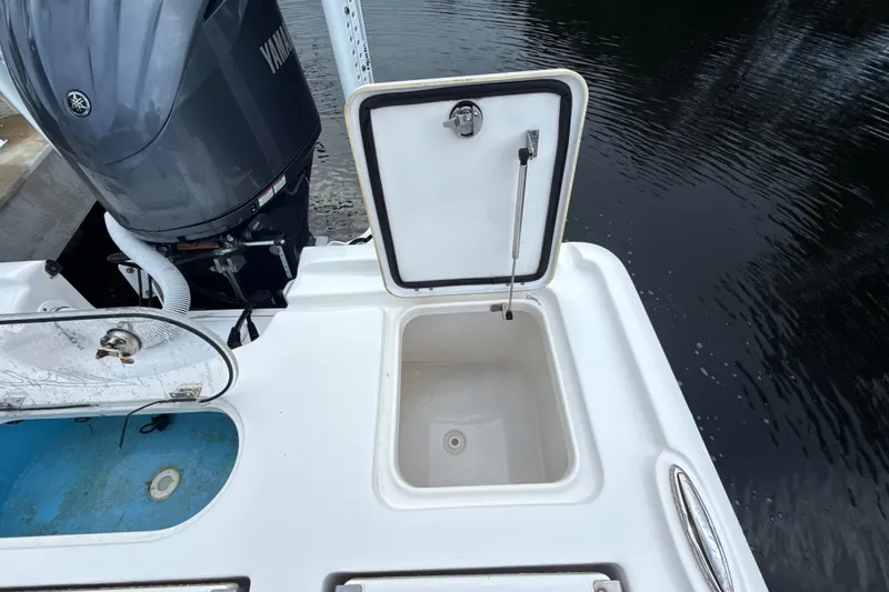 Slide: The Image of 2021 Tidewater 2500 Carolina Bay boat with open storage compartment and Yamaha engine. - 9